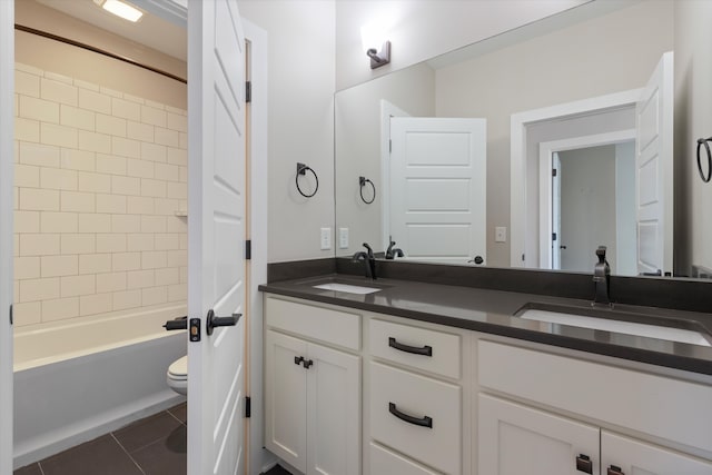 full bathroom with toilet, tiled shower / bath, vanity, and tile patterned flooring