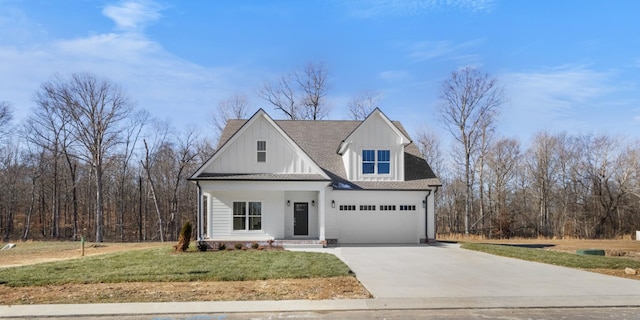 view of front of home with a garage and a front lawn