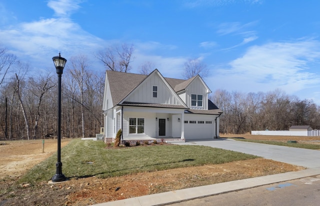 view of front of house with a garage and a front lawn