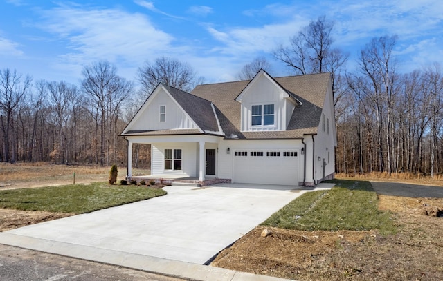 view of front of house featuring a porch, a garage, and a front yard