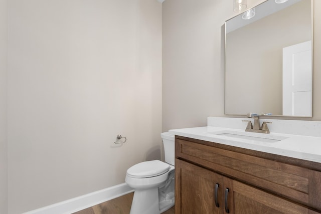 bathroom with vanity, hardwood / wood-style floors, and toilet