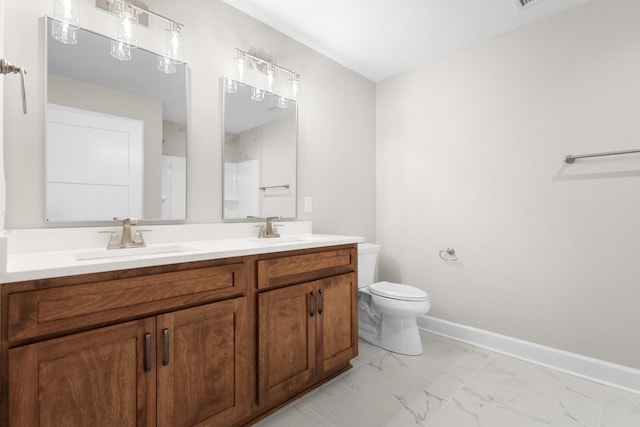 bathroom with vanity, a shower, and toilet