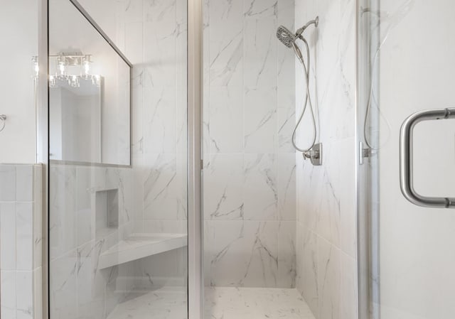 bathroom featuring a shower with door