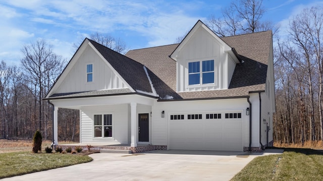 view of front of home with a garage, a front yard, and covered porch