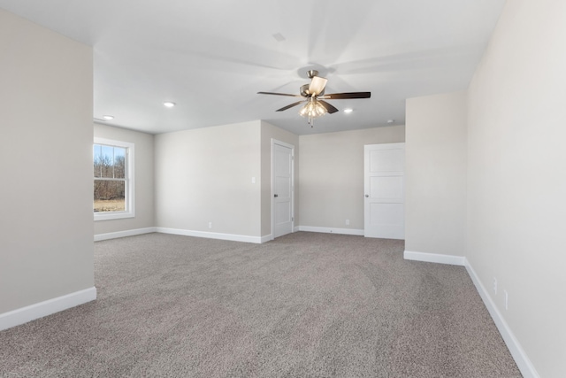 carpeted spare room with ceiling fan