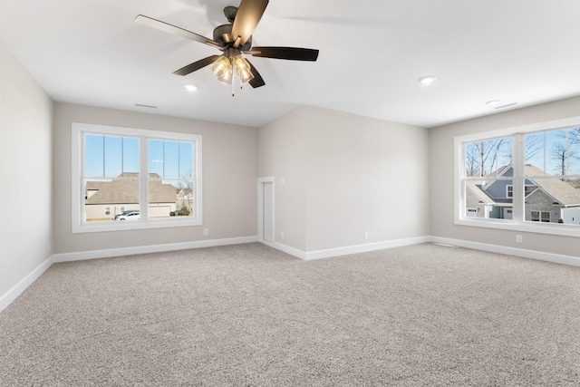 unfurnished room with ceiling fan, plenty of natural light, and carpet