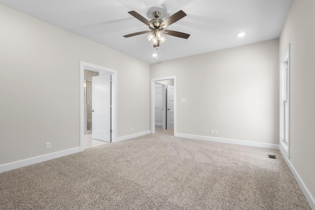 unfurnished bedroom featuring carpet flooring, connected bathroom, and ceiling fan