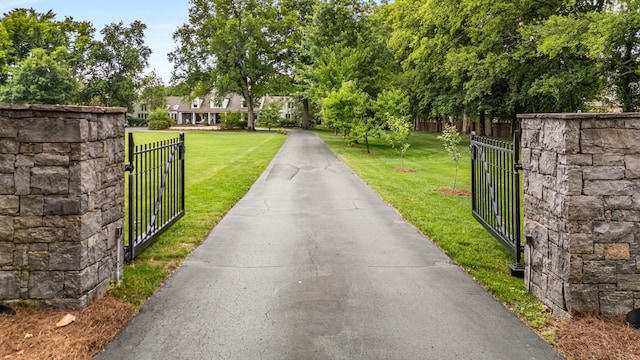 view of gate featuring a lawn