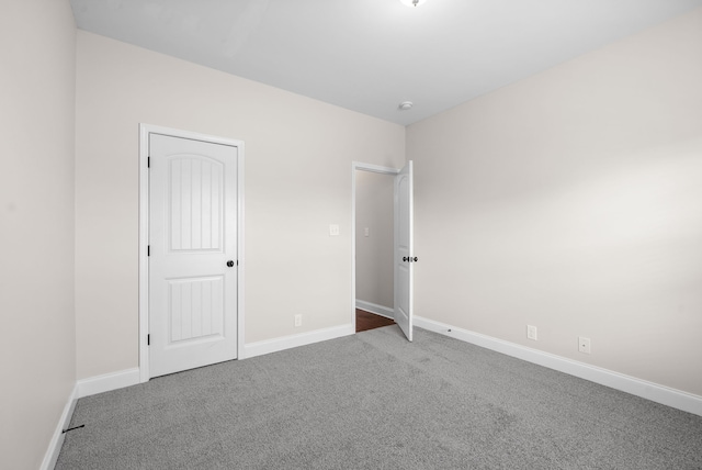 unfurnished bedroom featuring carpet and a closet