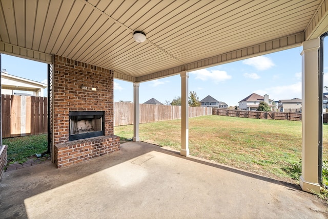 view of patio featuring an outdoor brick fireplace