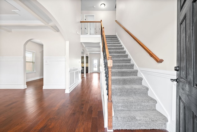 foyer entrance featuring beamed ceiling and dark hardwood / wood-style floors