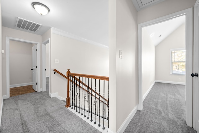 hallway with light colored carpet and lofted ceiling