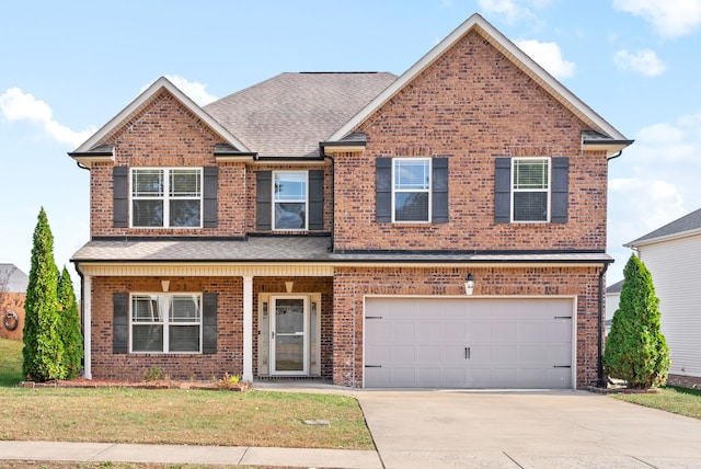 view of front of house with a garage and a front lawn