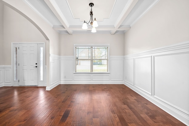 foyer featuring dark hardwood / wood-style flooring, an inviting chandelier, coffered ceiling, beamed ceiling, and crown molding