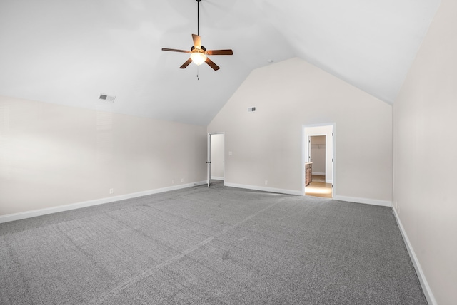 unfurnished living room with ceiling fan, vaulted ceiling, and carpet