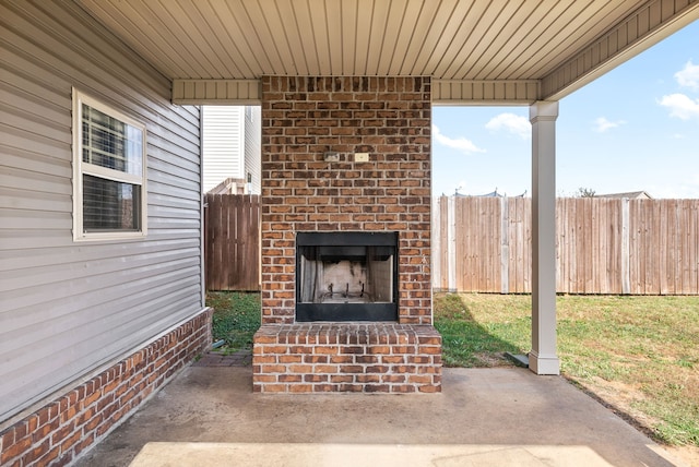 view of patio featuring an outdoor brick fireplace