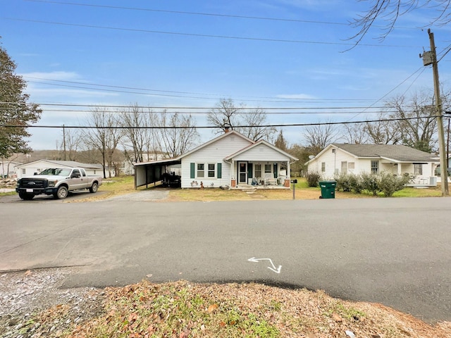 view of front facade with a porch and a carport