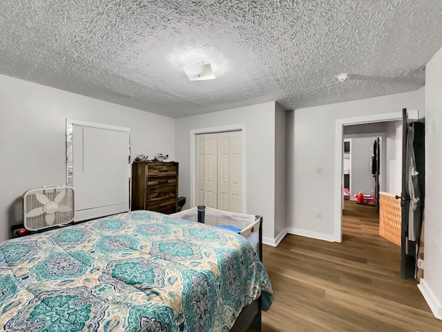 bedroom with hardwood / wood-style floors, a textured ceiling, and a closet