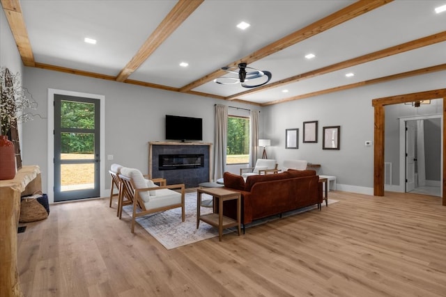 living room with light hardwood / wood-style floors, ornamental molding, beam ceiling, and ceiling fan