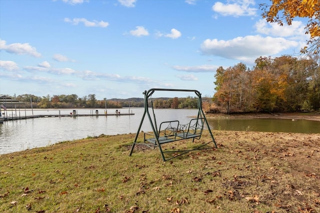 view of dock featuring a yard and a water view