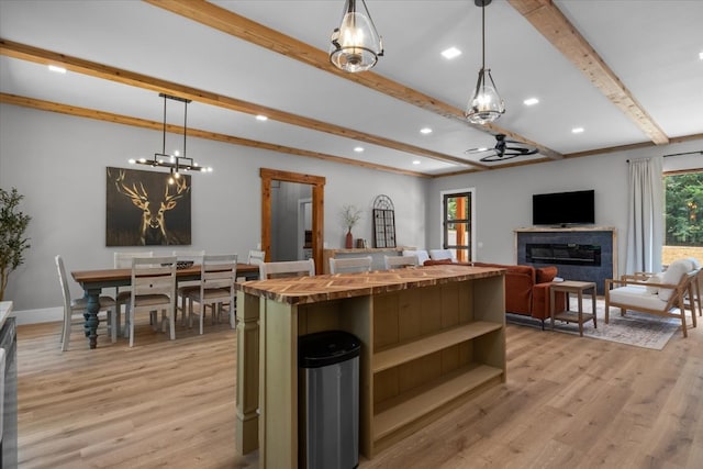 kitchen featuring light hardwood / wood-style flooring, wood counters, and hanging light fixtures