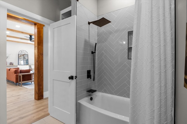 bathroom featuring hardwood / wood-style floors and shower / tub combo with curtain