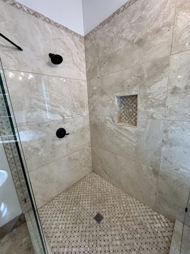 bathroom with a tile shower