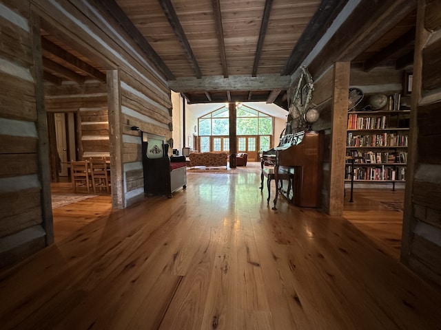 miscellaneous room featuring hardwood / wood-style floors and vaulted ceiling with beams