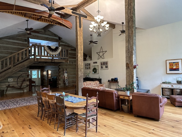 dining area with a notable chandelier, high vaulted ceiling, beamed ceiling, and light wood-type flooring