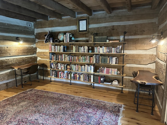 living area featuring beam ceiling and wood-type flooring