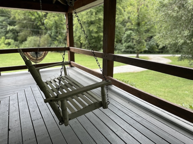 wooden deck featuring a lawn