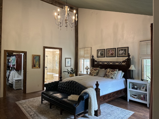 bedroom with dark hardwood / wood-style flooring, multiple windows, and ensuite bath