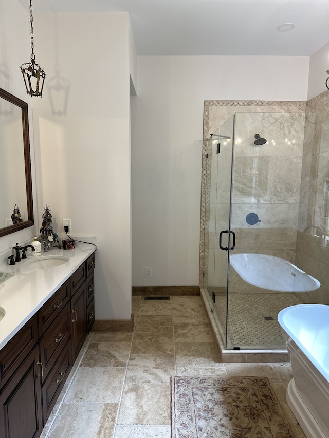 bathroom featuring vanity, a notable chandelier, and plus walk in shower