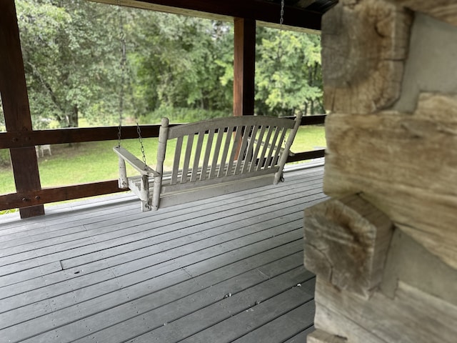 wooden deck featuring a lawn