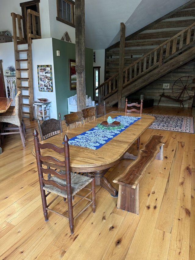 dining space featuring lofted ceiling and light wood-type flooring