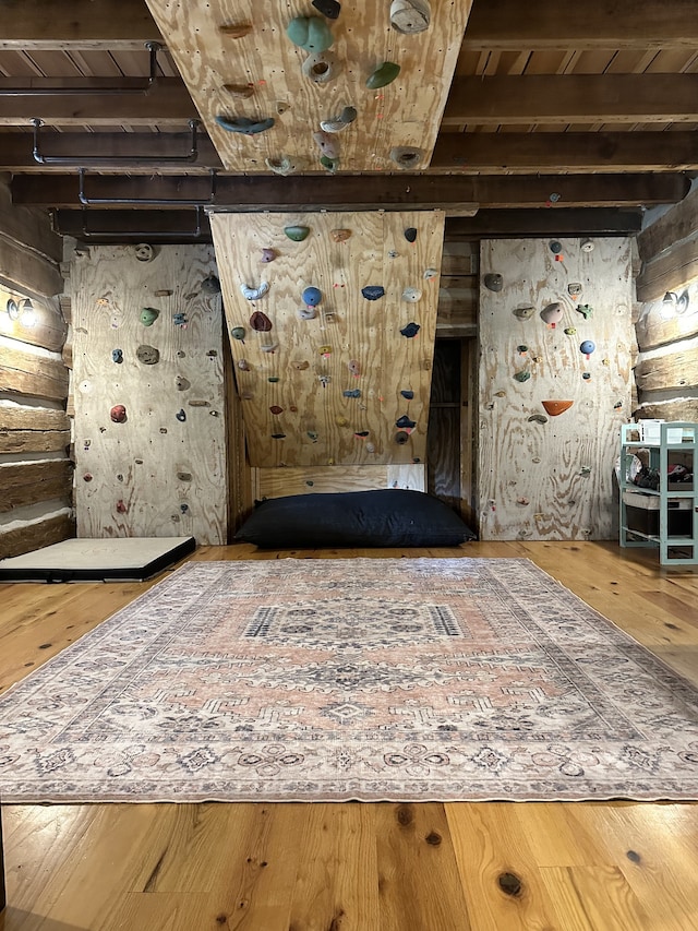 interior space featuring beamed ceiling, wood ceiling, and hardwood / wood-style flooring