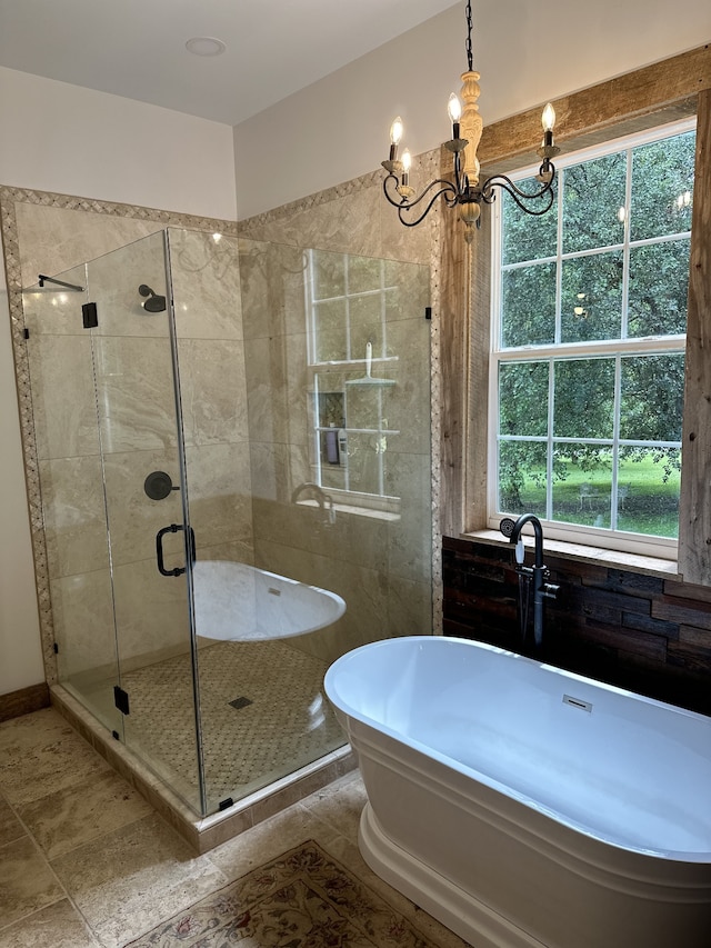 bathroom featuring independent shower and bath, a chandelier, and tile patterned flooring