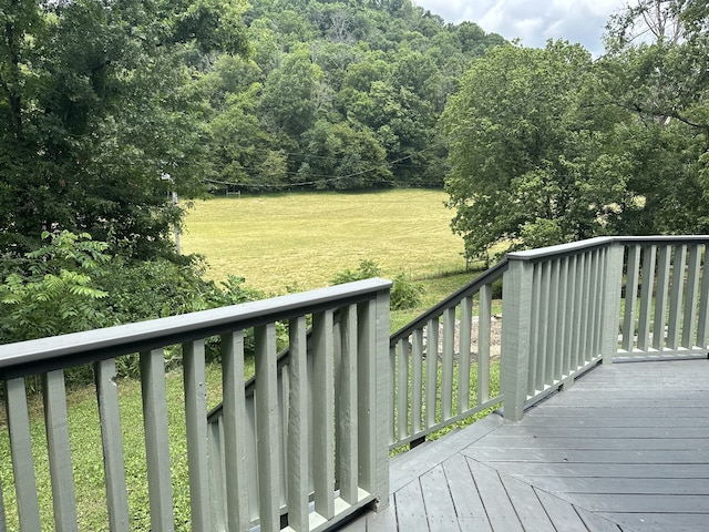 wooden deck with a lawn