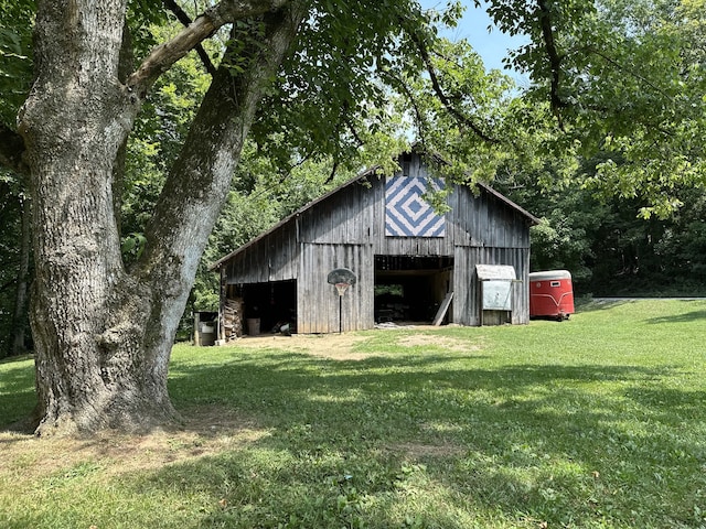 view of outbuilding featuring a lawn