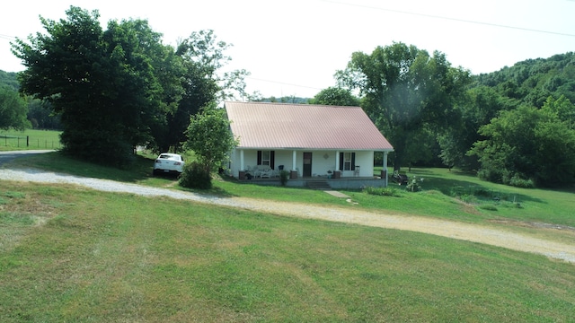 view of front of home with a front yard and covered porch