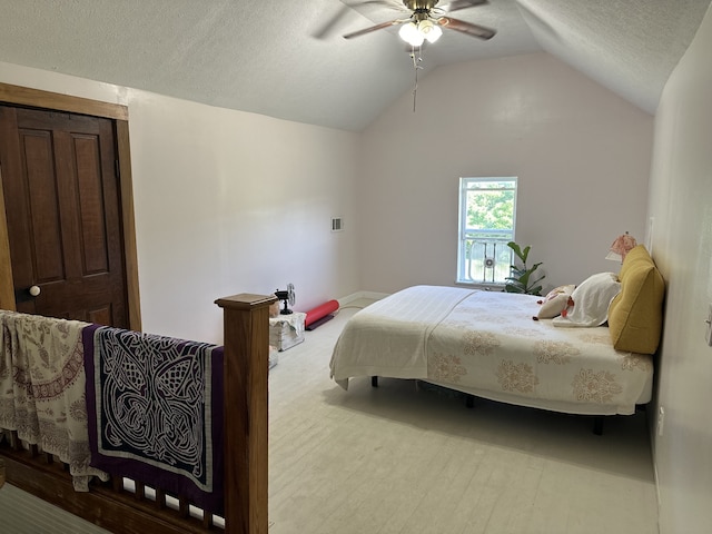 bedroom with a textured ceiling, vaulted ceiling, and ceiling fan