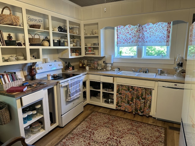 kitchen featuring white appliances, dark wood-type flooring, sink, and white cabinetry