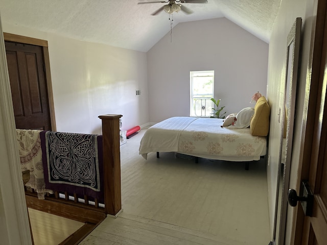 bedroom with ceiling fan, a textured ceiling, vaulted ceiling, and light wood-type flooring