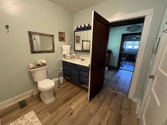 bathroom with vanity, hardwood / wood-style flooring, and toilet