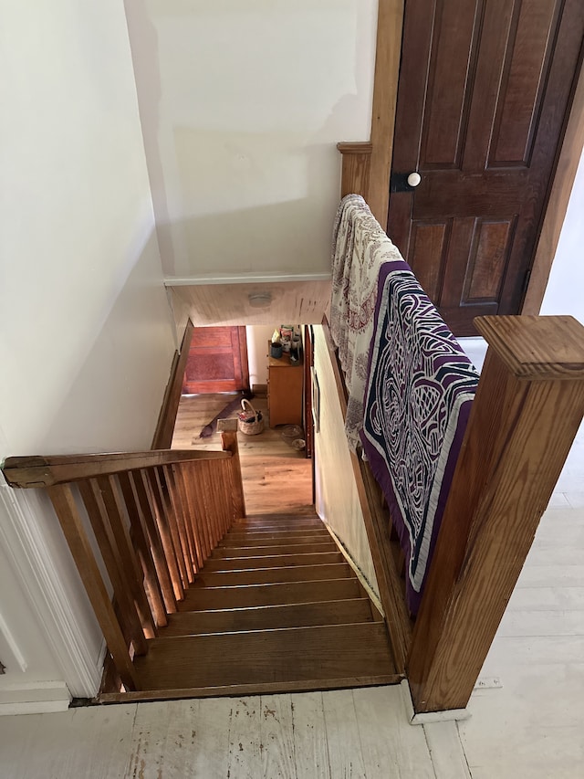 stairs featuring hardwood / wood-style flooring