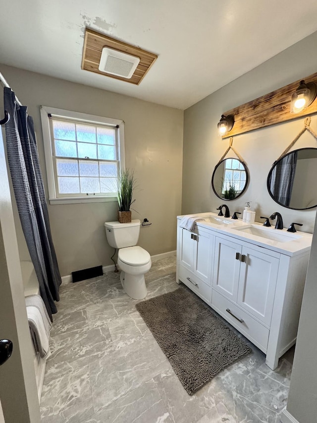 bathroom with toilet and vanity