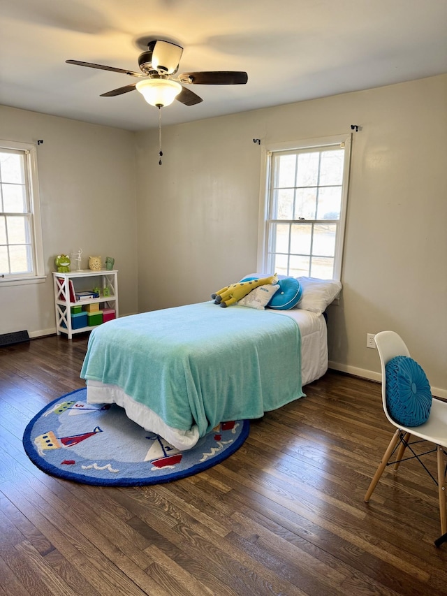 bedroom with ceiling fan and dark hardwood / wood-style flooring