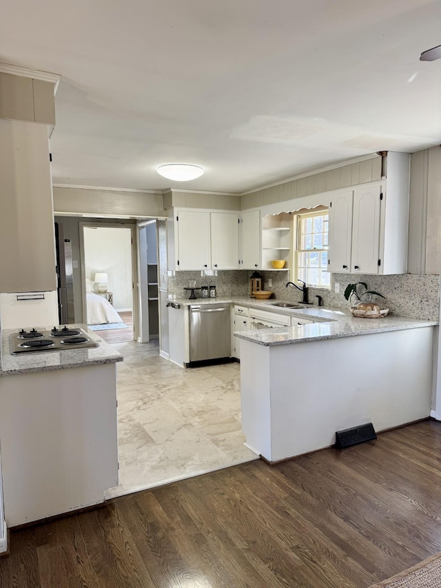 kitchen with hardwood / wood-style floors, dishwasher, white cabinetry, kitchen peninsula, and gas cooktop