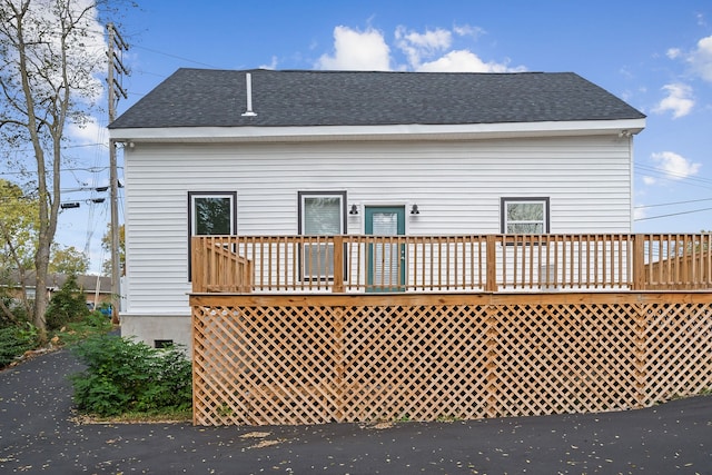 back of property featuring a wooden deck