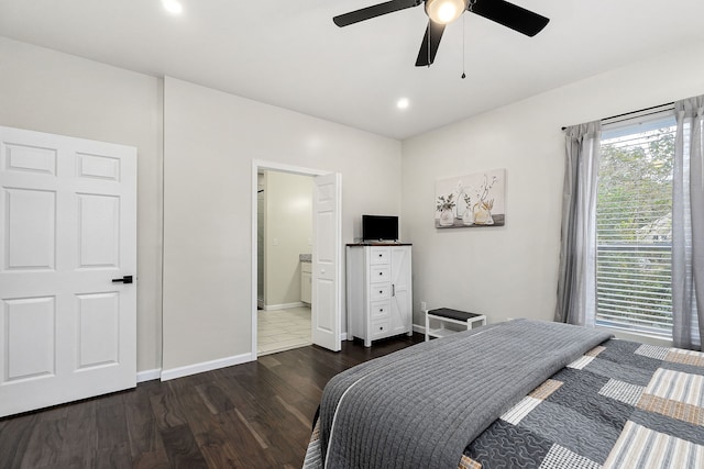 bedroom featuring ensuite bathroom, dark hardwood / wood-style floors, and ceiling fan